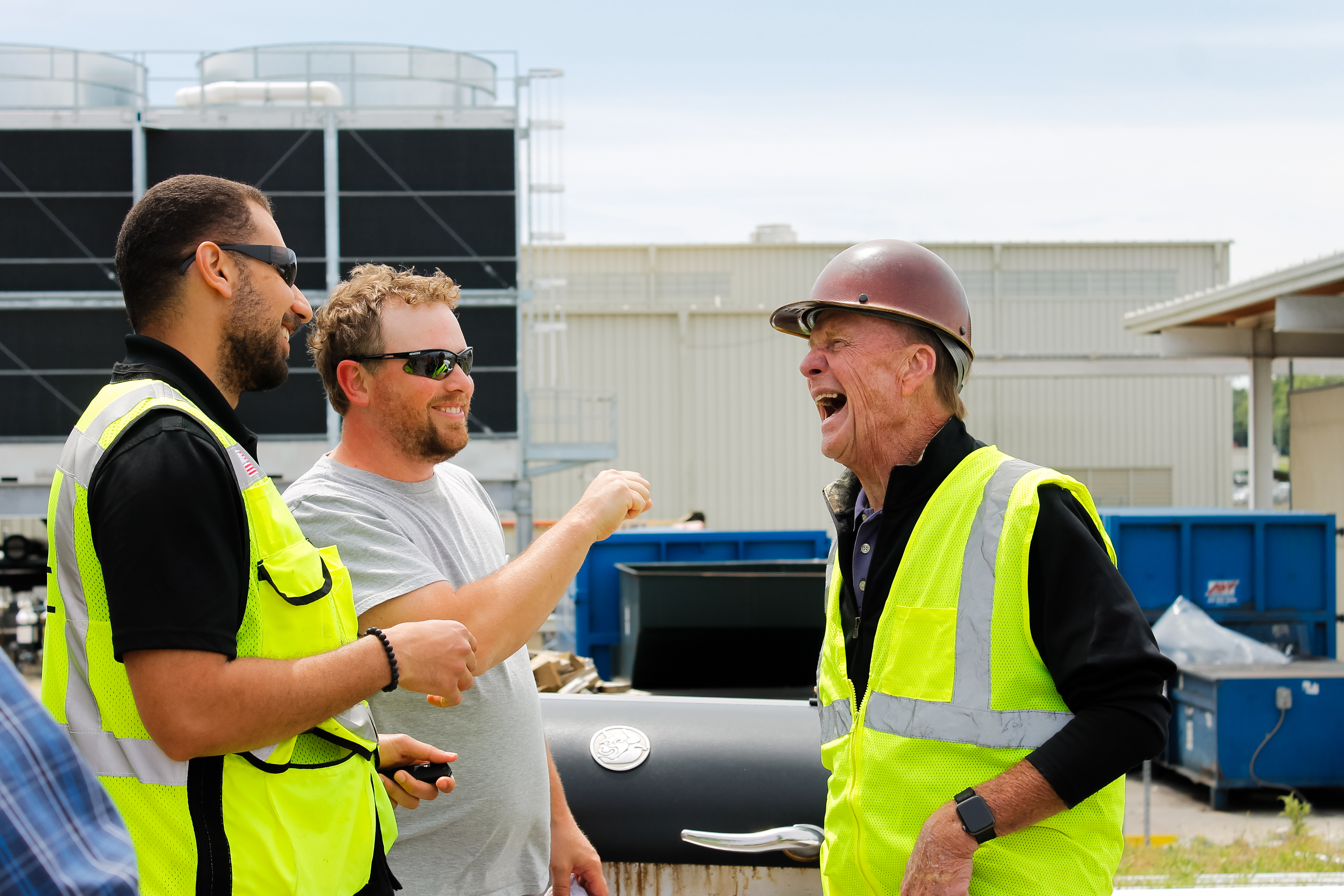 Gary laughing with guys at AESC cookout