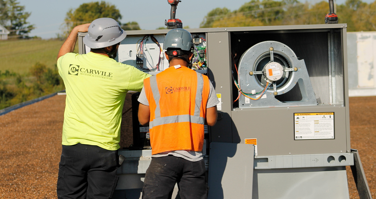 workers fixing hvac